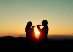 couple drinking wine at sunset