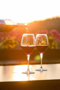 red wine pouring during sunset